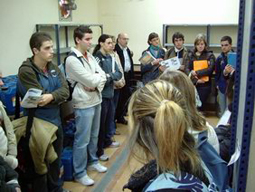 Group of people in the warehouse visit.