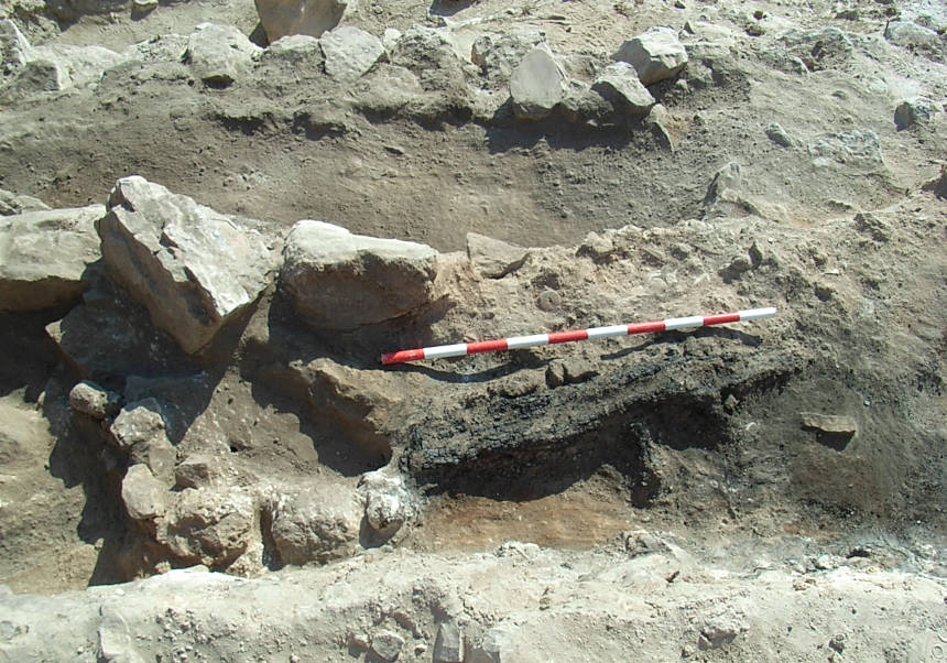 Remains of the loom’s wood during the excavation process.