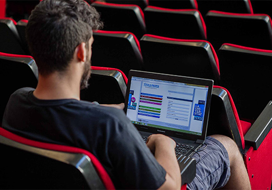 Student in a classroom with a laptop