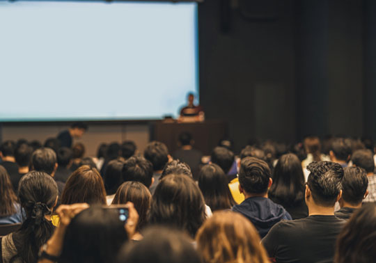 Group of people attending to a conference.