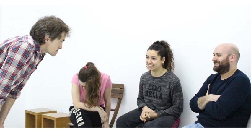 Photograph of four people talking