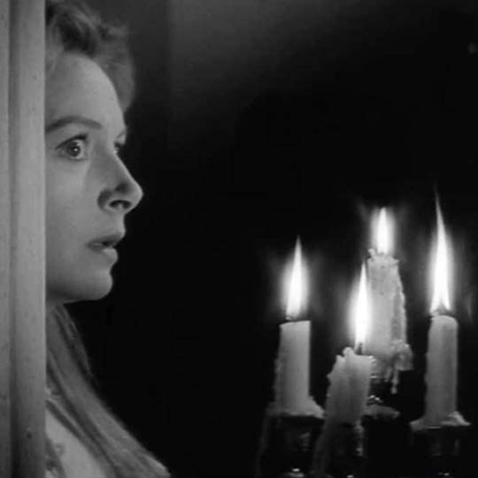 A woman with a candlestick