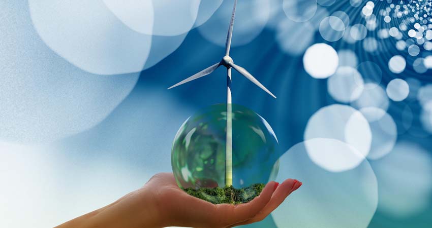 A hand, a terrarium ball and the blades of a windmill