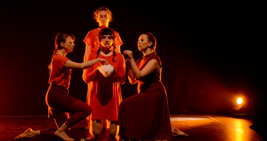 Three women and a man on a stage