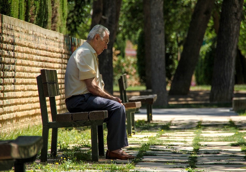 Persona major asseguda en un banc