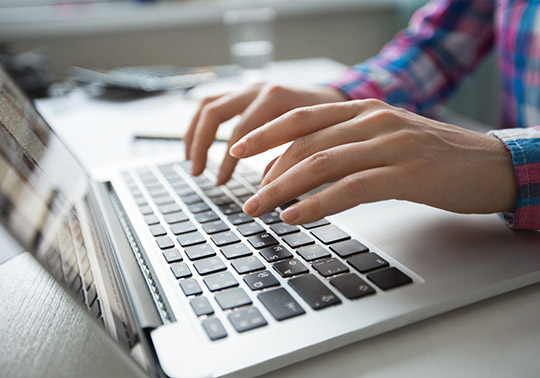 Person writing in a computer