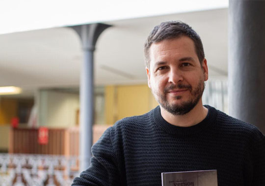 Photo of Pau Alabajos with a book in his hands.