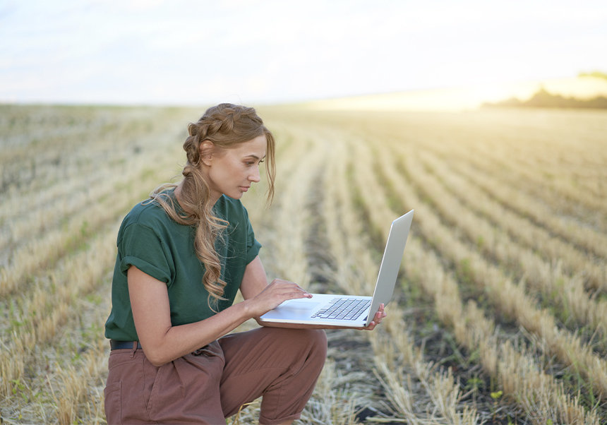Person with laptop in a field.Call for the Best Academic Project for Agri-Food Cooperatives Award