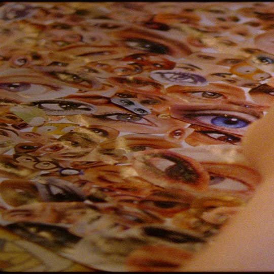 A hand moving eye photo cutouts