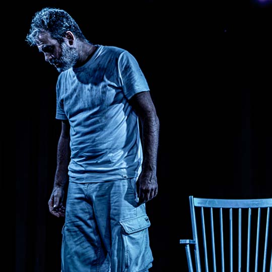 A man and a chair on stage