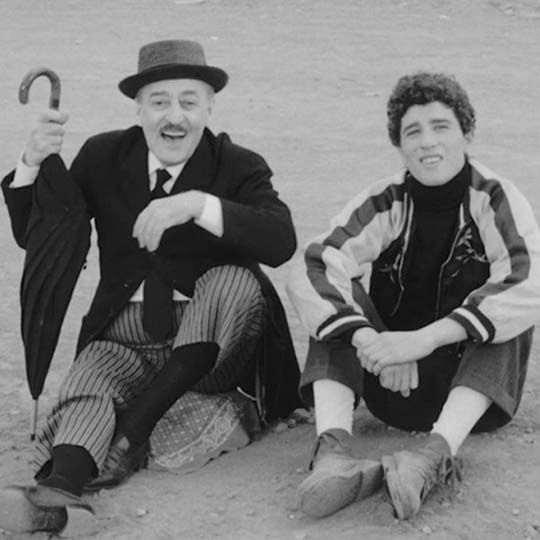 A man and a young man sitting on the floor