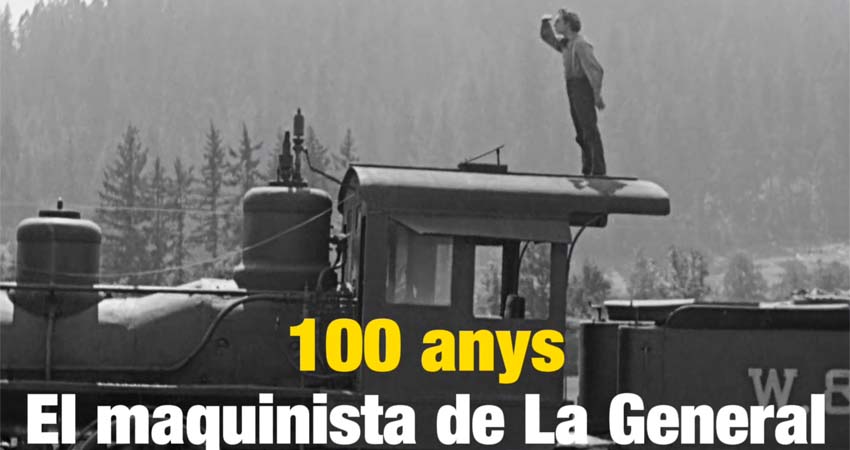 A man on top of a locomotive