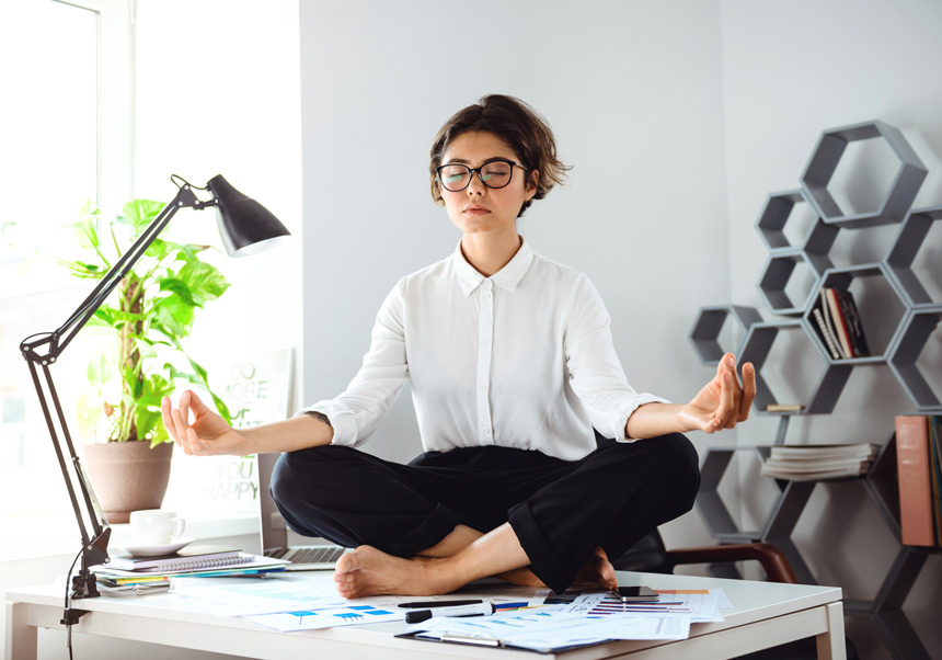woman meditating on an office table
