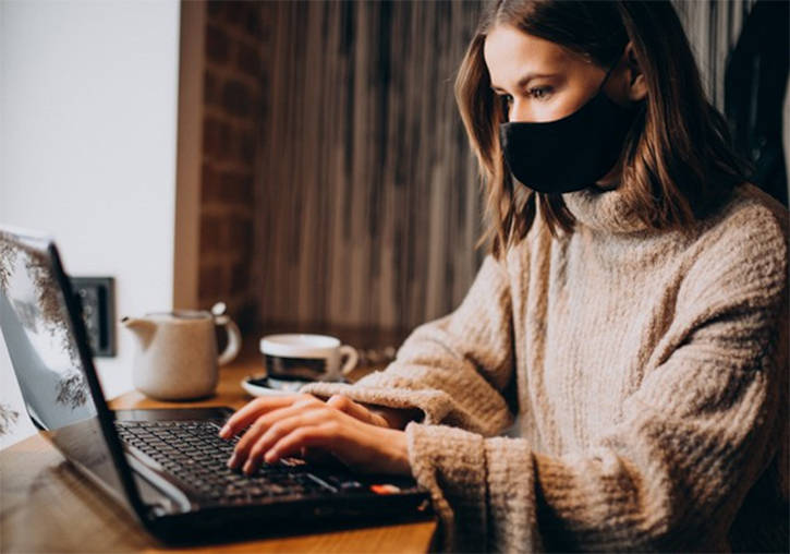 Una dona treballa des de casa connectada amb l'ordinador.
