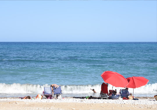 Picture of a beach with umbrellas.
