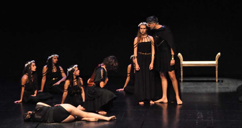 Group of actors and actresses performing on stage