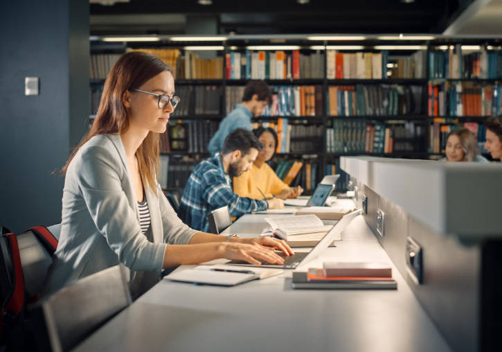 A young woman studies in the library.