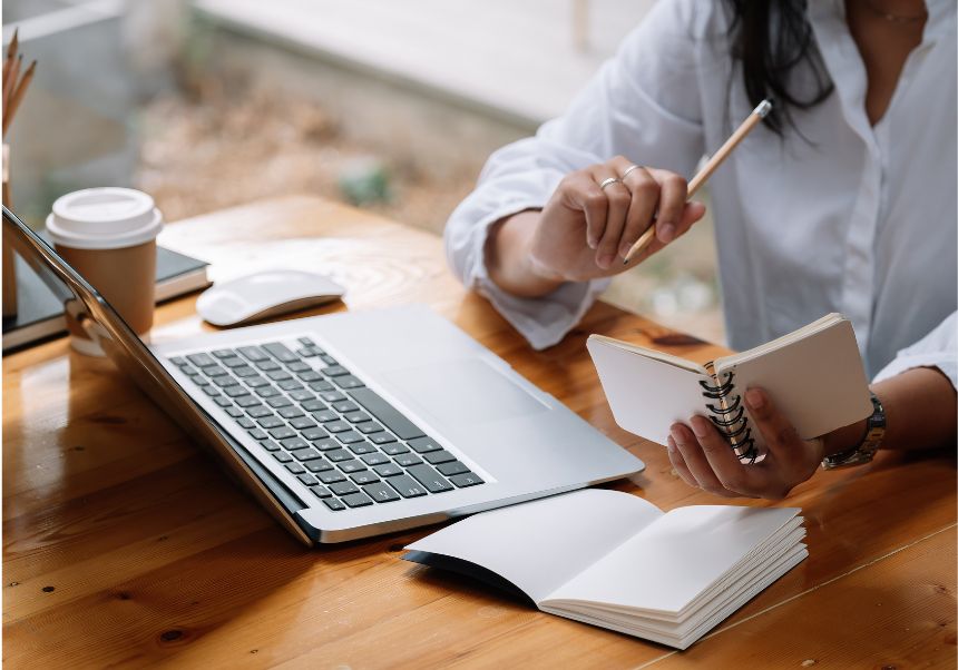 woman with book and laptop
