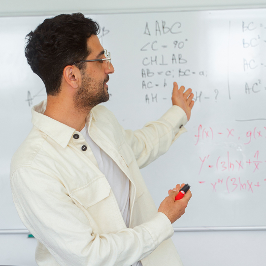 Young person writing on the blackboard