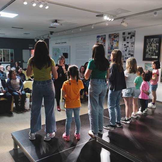 Group of girls singing in front of the audience