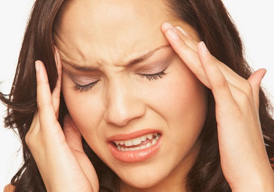 Woman with headache gesture