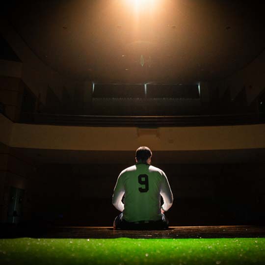 A man sitting with his back to the camera