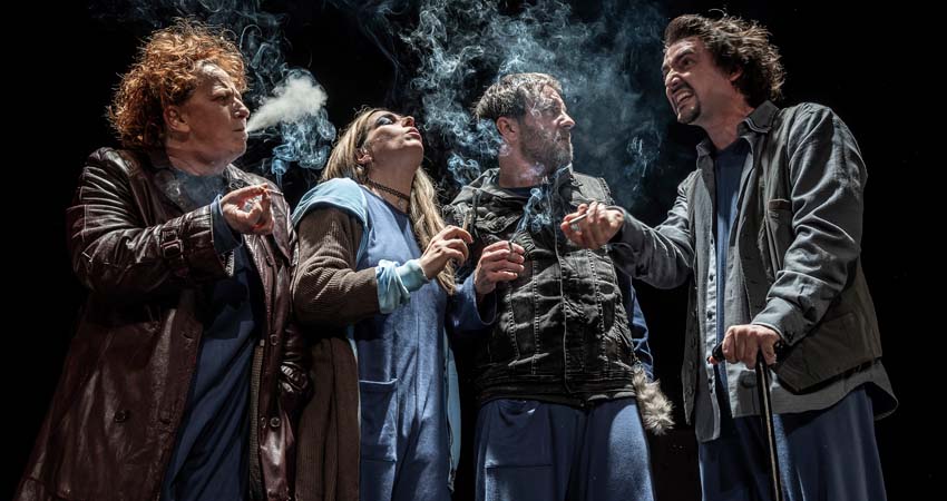 Four people smoking on stage