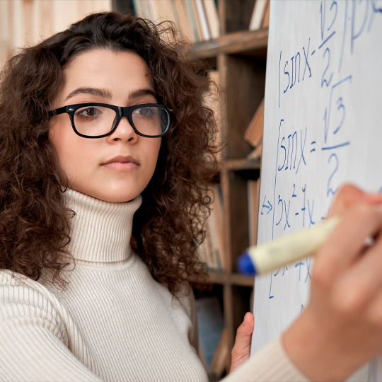 Young person writing on the blackboard