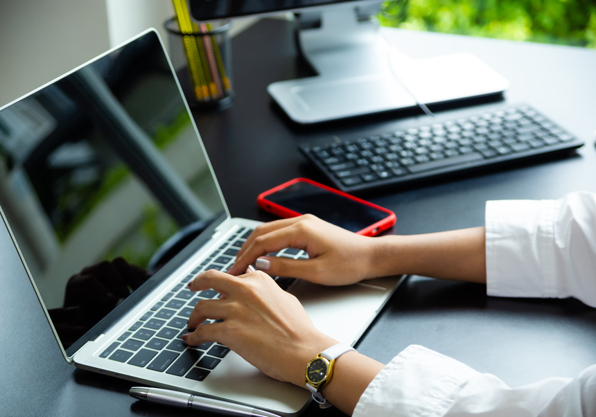 Person writing in a computer