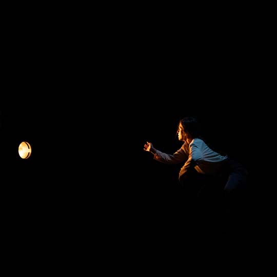 A woman looking at a spotlight