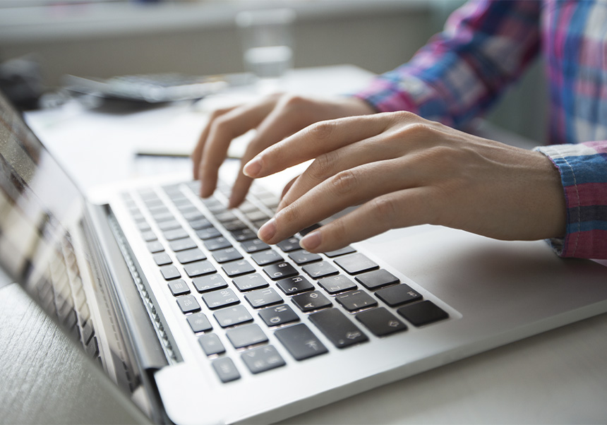 Person writing in a computer