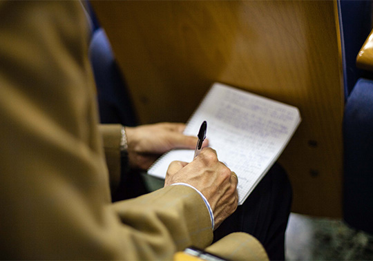 Person taking notes in a notebook