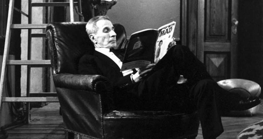 Seated man reading a magazine