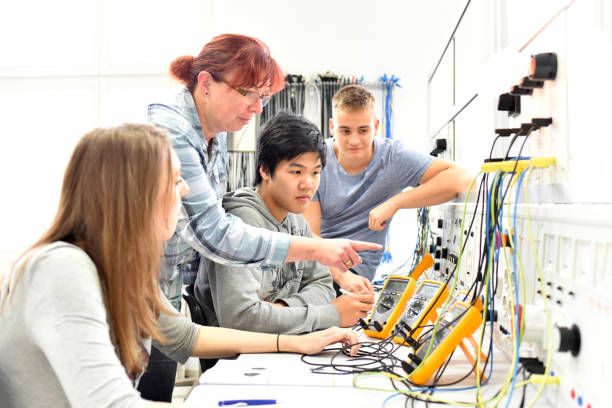 Group of young people in professional electronics training situation