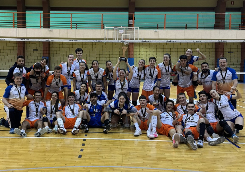 The UV volleyball teams pose with their medals and trophies.