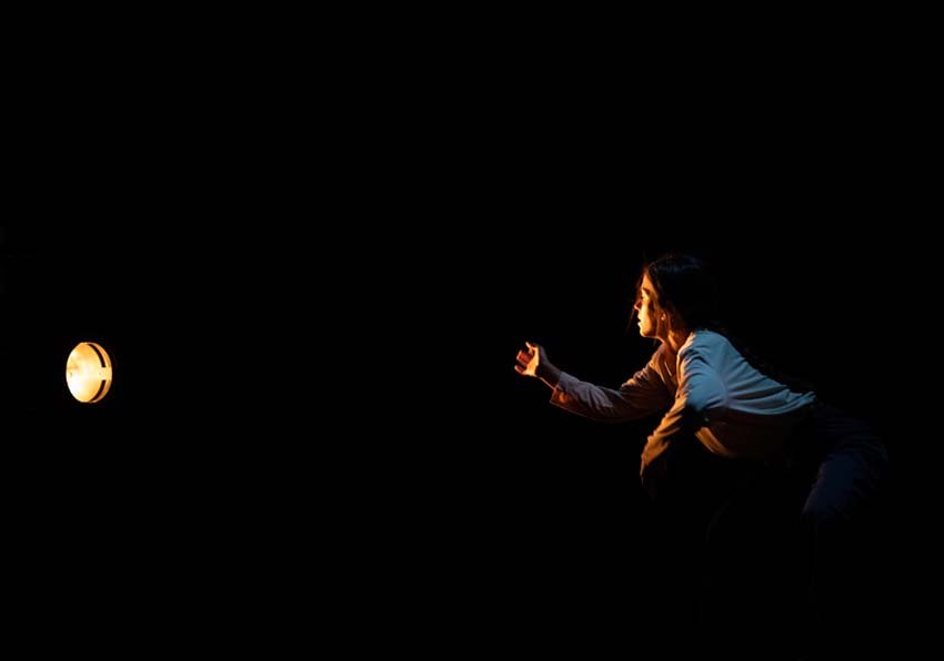 A woman looking at a spotlight