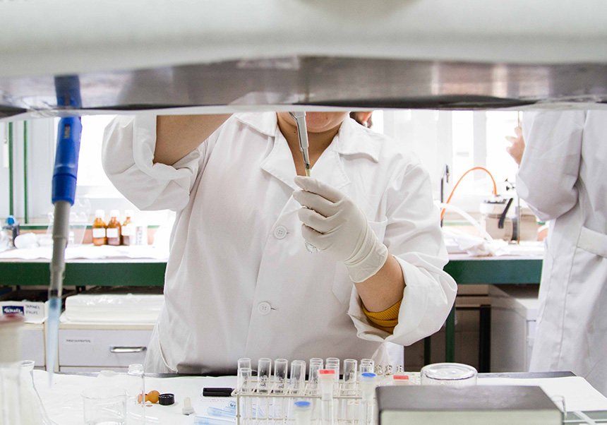 A person is seen filling a test tube with a syringe