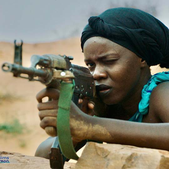 A woman aiming a rifle