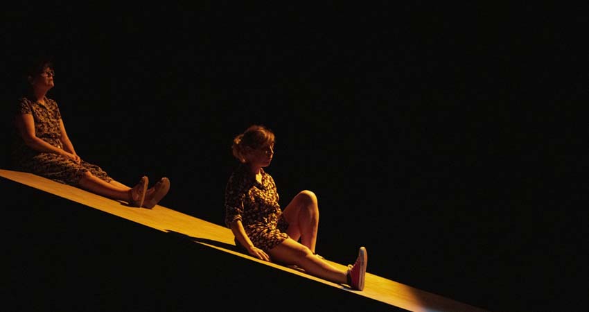 Two women sitting on a stage