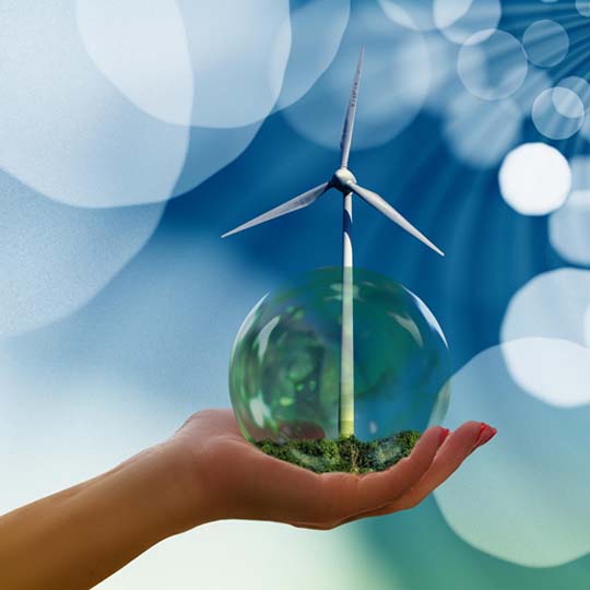 A hand, a terrarium ball and the blades of a windmill