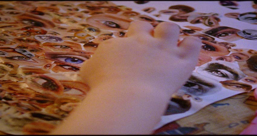 A hand moving eye photo cutouts