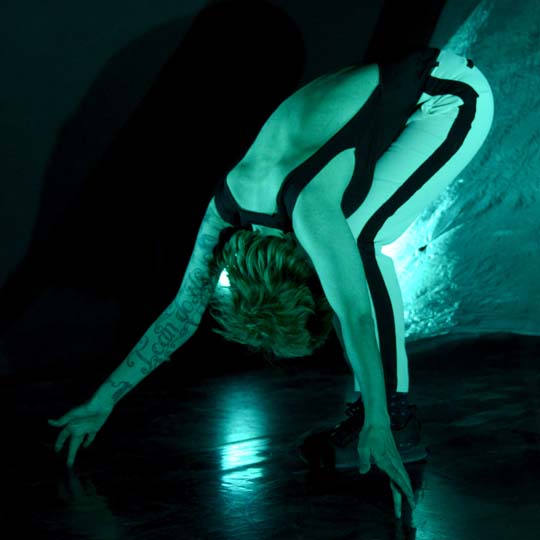 A person crouching on the stage