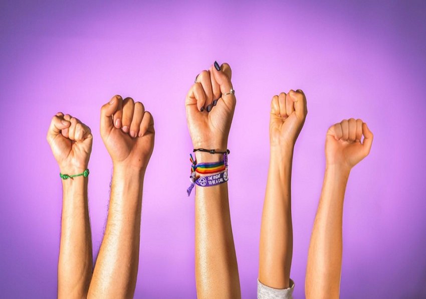 Raised fists on a purple background.
