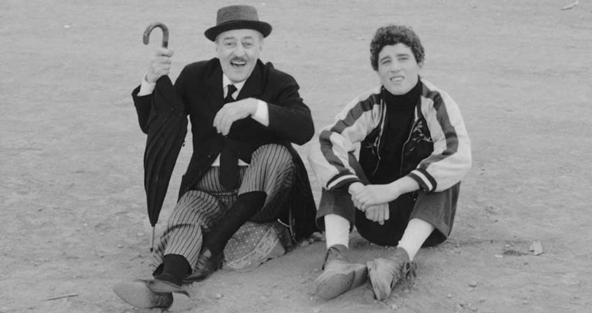 A man and a young man sitting on the floor