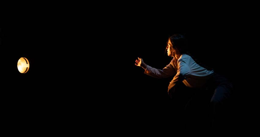 A woman looking at a spotlight