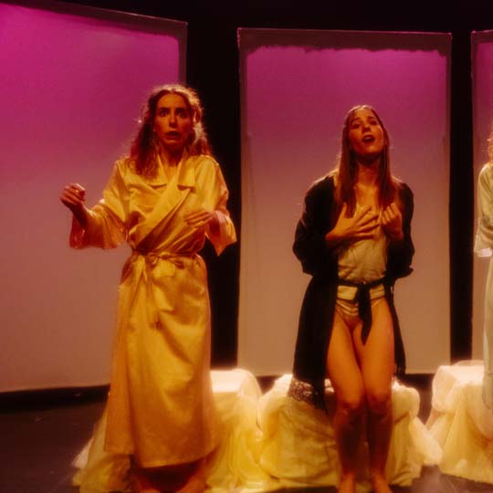 Three women on a stage