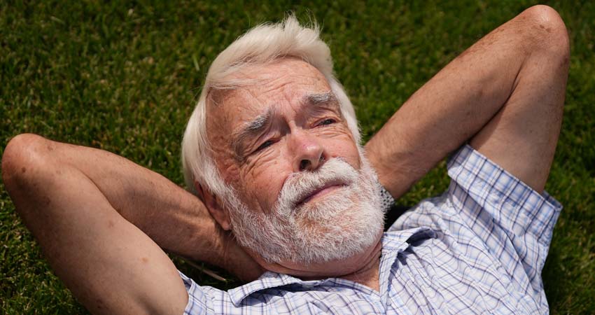 Photo of a man lying on the grass